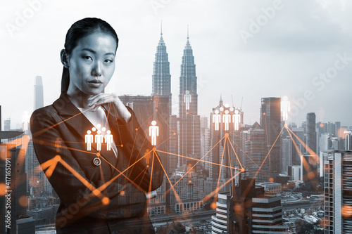 Photography Attractive young Asian HR director at international company is thinking about recruitment of highly qualified specialists