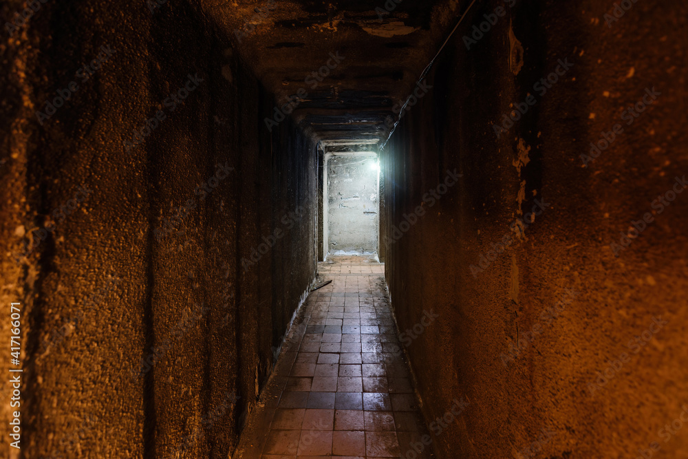 Dark corridor of old underground Soviet military bunker under artillery fortification
