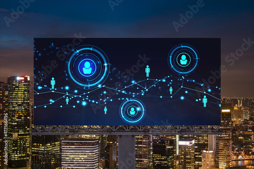 Glowing Social media icons on billboard over night panoramic city view of Singapore. The concept of networking and establishing new connections between people and businesses in Southeast Asia photo