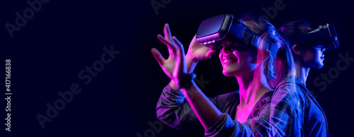 Future game and entertainment digital technology. Teenager having fun play VR virtual reality glasses sport game 3D cyber space metaverse digital world futuristic augmented reality photo