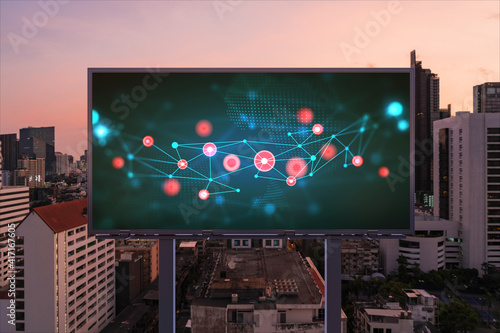 Information flow hologram on road billboard, night panorama city view of Bangkok. The largest technological center in Southeast Asia. The concept of programming science.