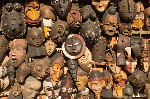 Traditional african masks hanging for sell in a market stall