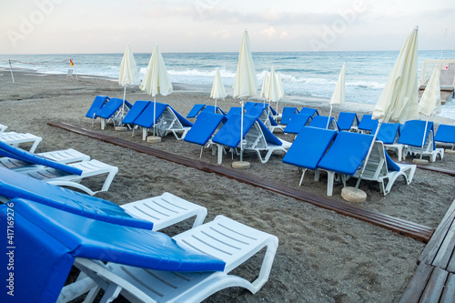Chairs on the sandy beach near the sea