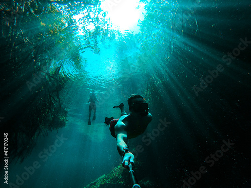 Man takes selfie while freediving in Casa Cenote in Tulum, Quintana Roo, Mexico