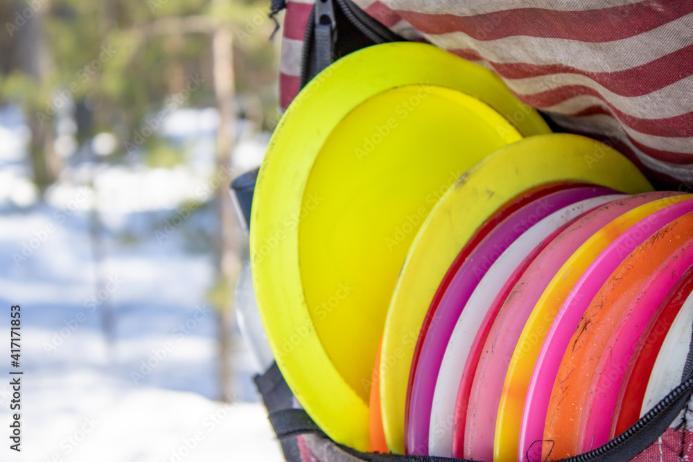 yellow discs in the disc golf bag