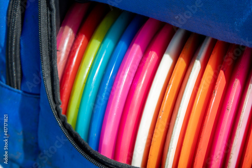 disc golf bag and discs in many colors photo