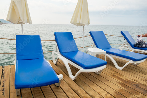 pier with benches on it ready for summer vacation on the white sea