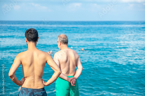 Guy and his father looking at the sea