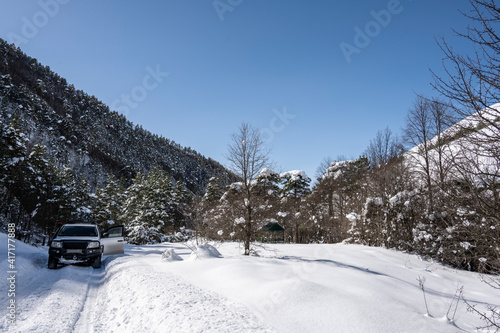 panoramic landscape of winter mountains, passes and snow-covered trees in the Caucasus 