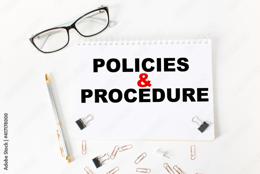Notepad with inscriptions POLICIES AND PROCEDURE on a white background. business concept. Notepad with inscriptions POLICIES AND PROCEDURE on a white background. business concept.