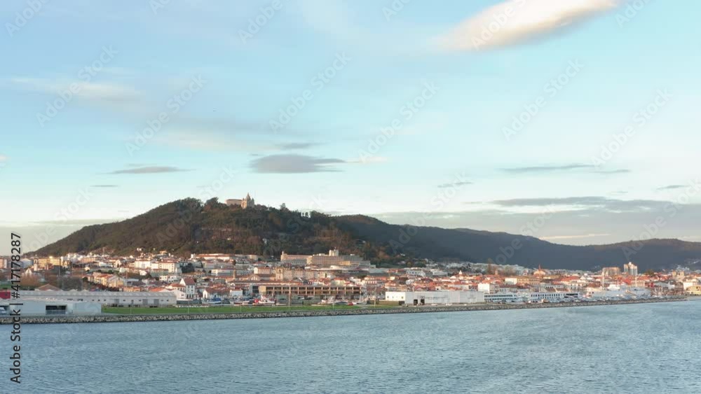 View to Viana do Castelo cityscape over the Lima river waterfront - Aerial wide slide tracking shot View to Viana do Castelo cityscape over the Lima river waterfront - Aerial wide slide tracking shot
