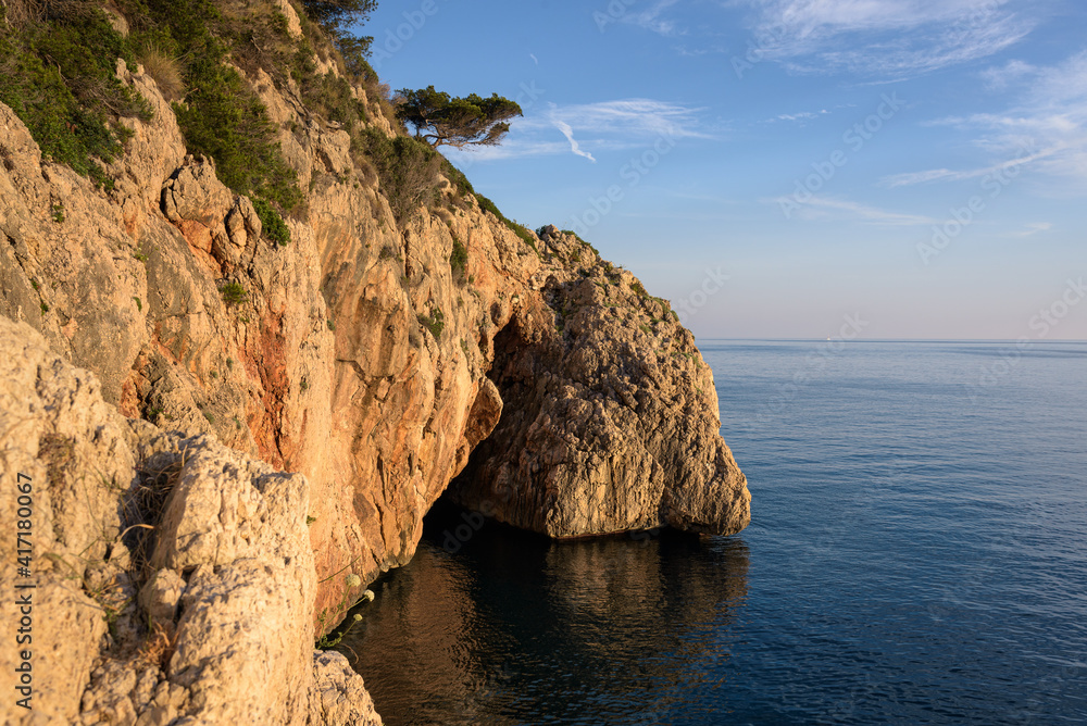 Coastal cliffs on the coast of Cape Nao in the Mediterranean sea at sunset, Javea, Alicante, Spain