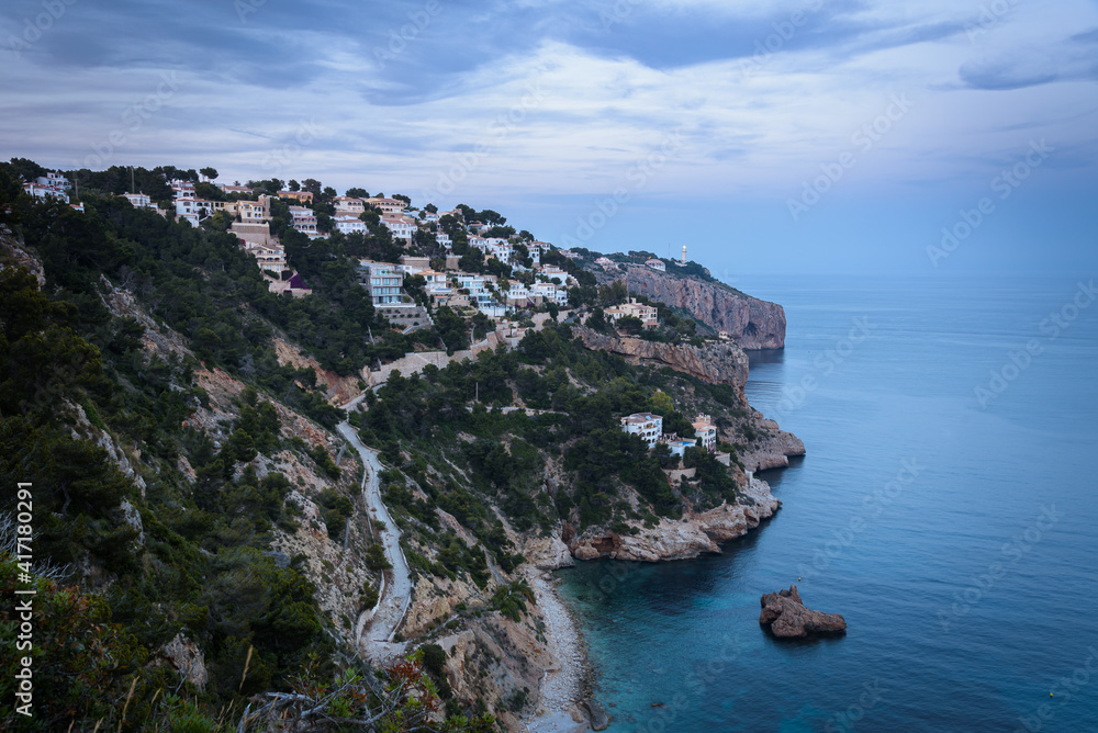 Residential area on top of a cliff on the coast of Cape Nao in Javea on a cloudy day in summer, Javea, Alicante, Spain