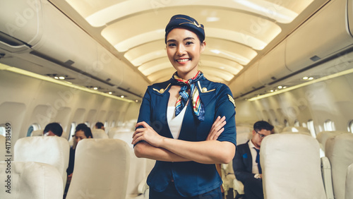 Cabin crew or air hostess working in airplane . Airline transportation and tourism concept. photo