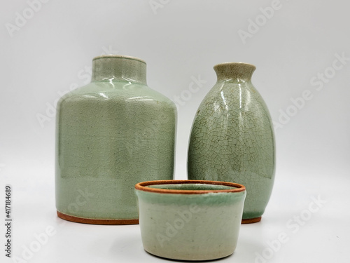 Antique green pottery  Sake Bottle in white background for decoration and collectible
