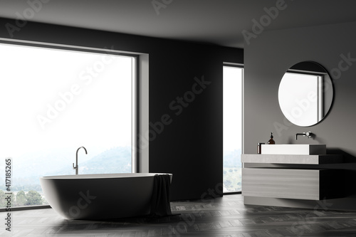 Modern bathroom interior with sink and white bathtub near window in eco minimalist style. wooden parquet floor. No people. 3D Rendering