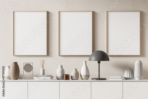 Three mock up posters frame on wall in modern interior background, living room. Books vase lamp on cabinet. Scandinavian style. 3D rendering. © ImageFlow