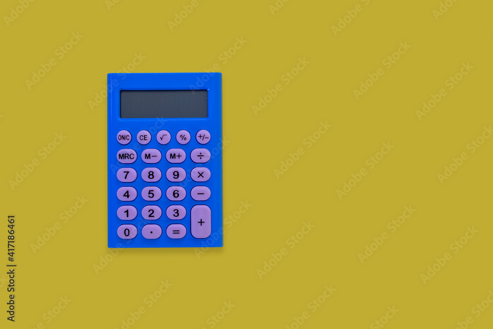 blue calculator with white keys on yellow background. Space for text. blue calculator with white keys on yellow background. Space for text.