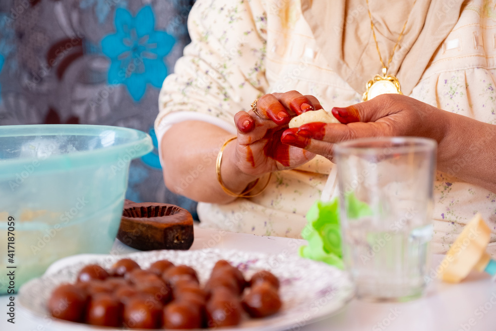 Arabic woman hands making eid sweets ,cookiesand mamoul Arabic woman hands making eid sweets ,cookiesand mamoul