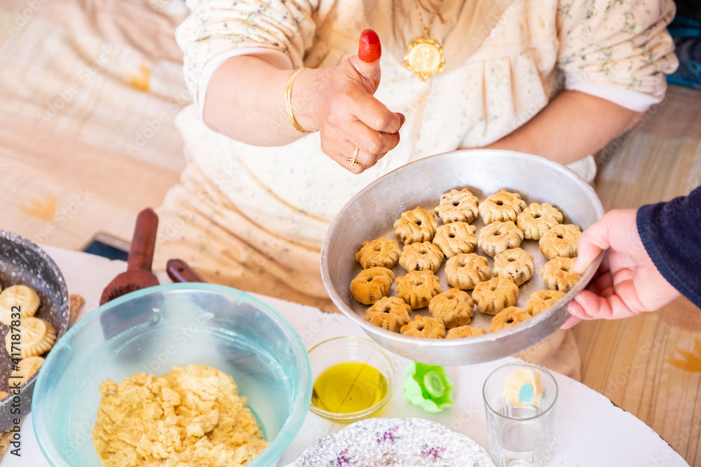 Arabic woman hands making eid sweets ,cookiesand mamoul Arabic woman hands making eid sweets ,cookiesand mamoul