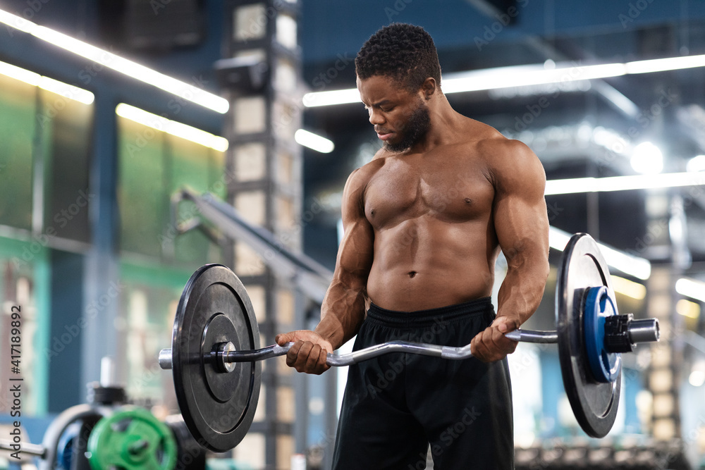 Athletic black man making powerlifting at gym, holding barbell Athletic black man making powerlifting at gym, holding barbell