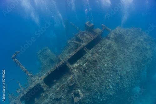 Underwater sunken ship wreck covered in coral