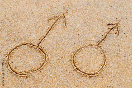Male gender symbols written on sand beach. Gay symbol. 11.08.2017