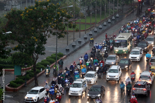 Vietnam, Ho Chi Minh City. Heavy monsoon rain. Motor Scooters and cars on Saigon Street. 11.08.2017