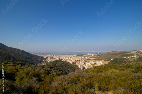 Built village houses and forest trees in deforestation area in the Turkey, İzmir. Concept of environment, ecology, global warming, climate change, social issues, urban.