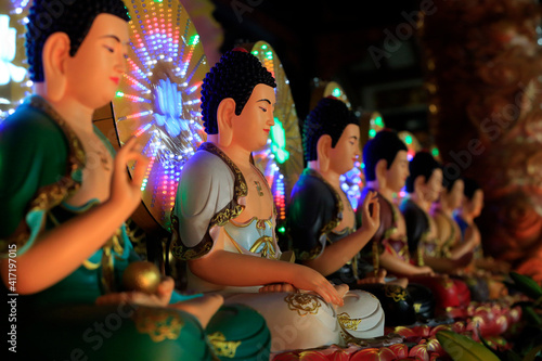 Chua Vinh Nghiem buddhist pagoda. Altar with Buddha statues. The Vitarka mudra : gesture of discussion and transmission of Buddhist teaching. Ho Chi Minh City. Vietnam. 25.02.2017