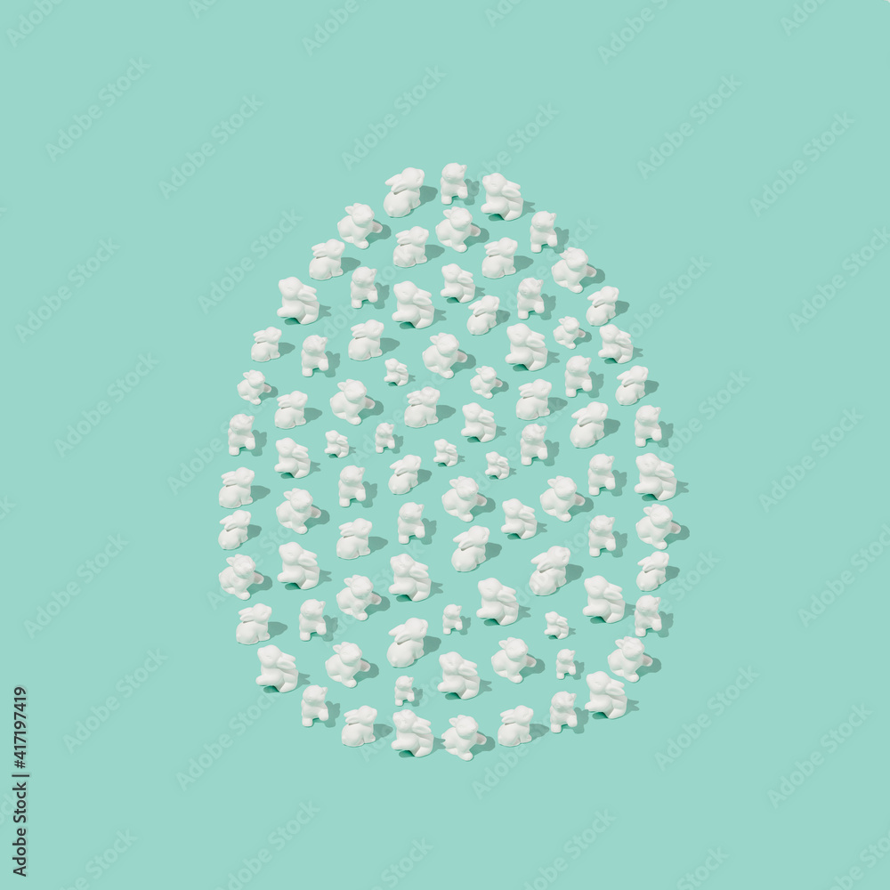 Easter composition made of white easter bunnies in an egg shape. Minimal holiday concept Easter composition made of white easter bunnies in an egg shape. Minimal holiday concept