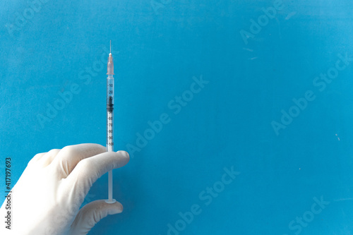 Vaccine in vial and syringe close-up on a white table gray background, medical concept, laboratory, subcutaneous injection vaccination, dose. Disease treatment immunization