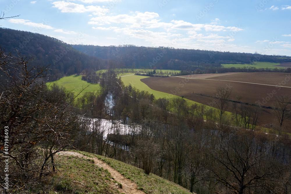 panoramic view of a beautiful landscape with a river and trees under a blue sky