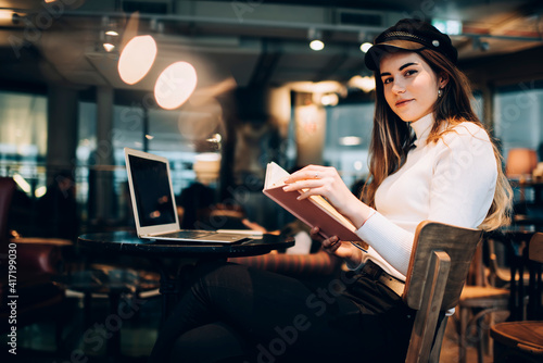 Calm female with notebook in cafe