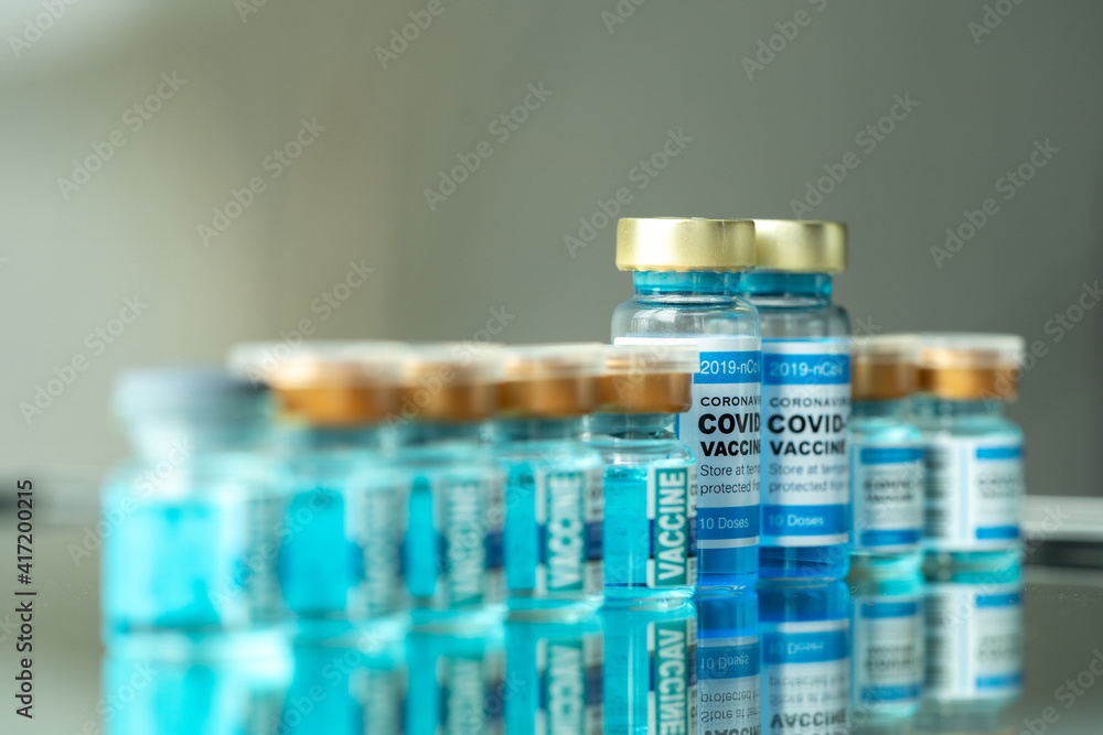 Medical concept ampoules or vials with Covid-19 vaccine on a laboratory bench