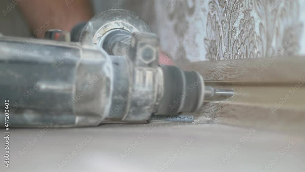 Installation of a plastic floor skirting board with a cable channel. Installation of a plastic floor skirting board with a cable channel.