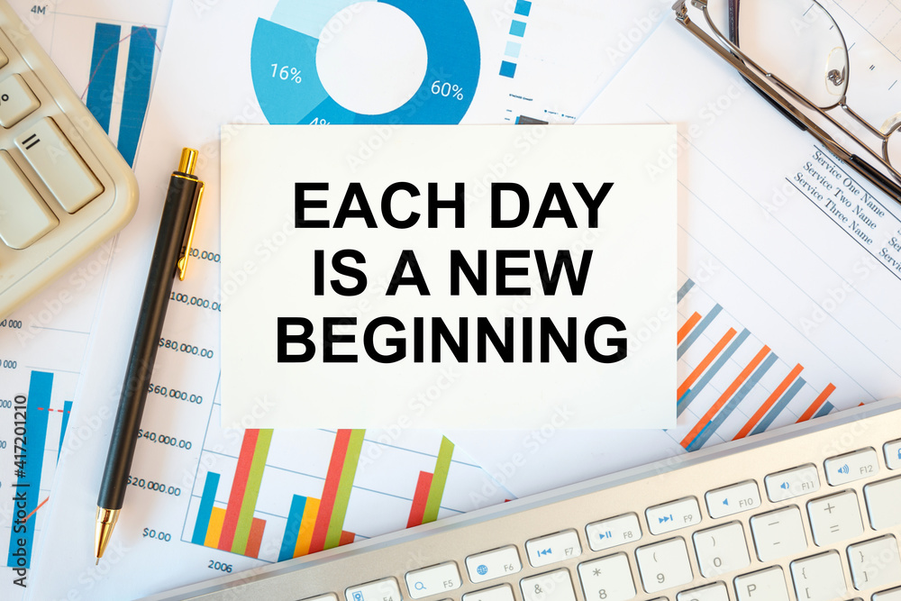 Obraz premium Each day is a new beginning is written in a document on the office desk, diagram and keyboard