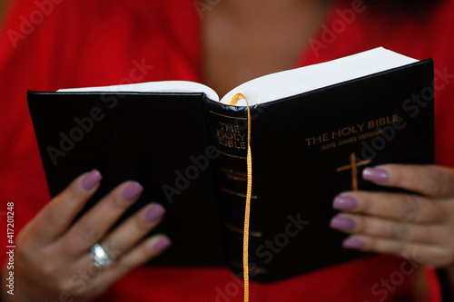 African woman reading the bible. Madagascar. 16.08.2019