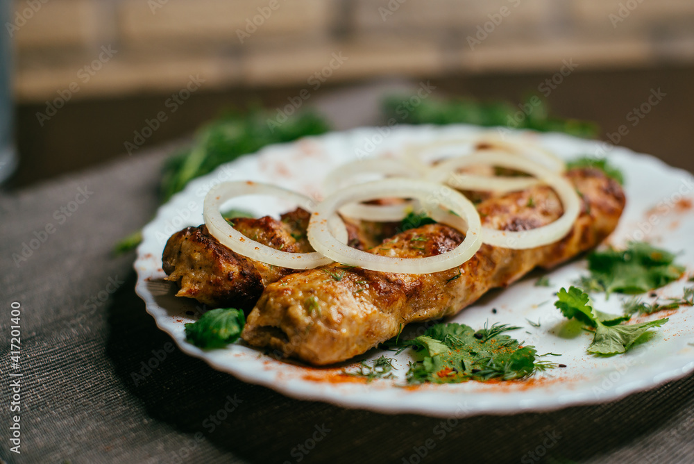 shish kebab on a plate with onions
