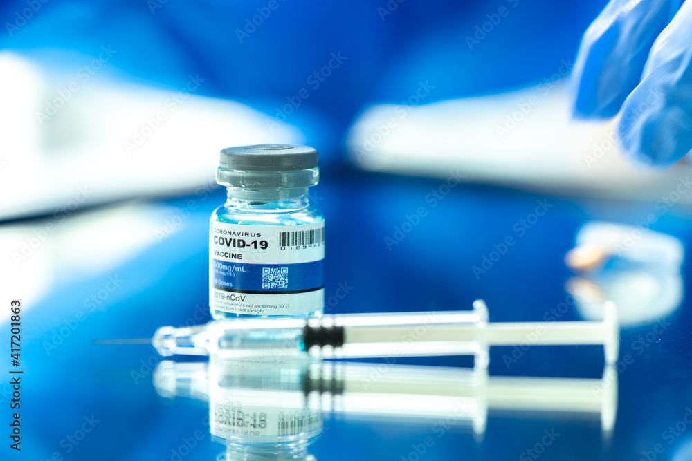 Medical concept ampoules or vials with Covid-19 vaccine on a laboratory bench Medical concept ampoules or vials with Covid-19 vaccine on a laboratory bench