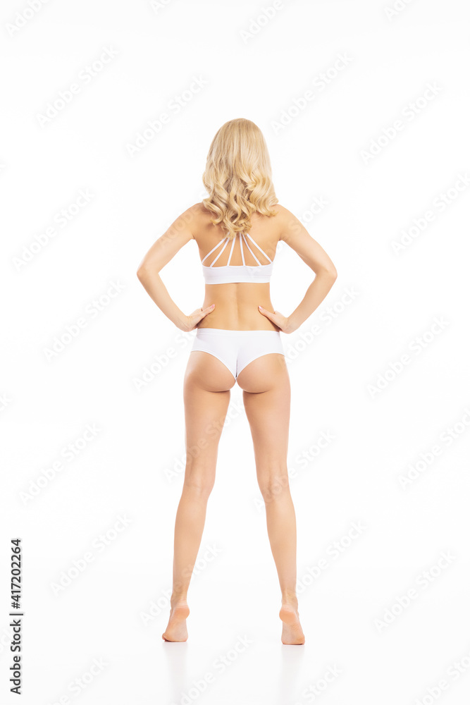 Young, fit and beautiful blond woman in white swimsuit isolated on white. Healthcare, diet, sport and fitness concept. Young, fit and beautiful blond woman in white swimsuit isolated on white. Healthcare, diet, sport and fitness concept.