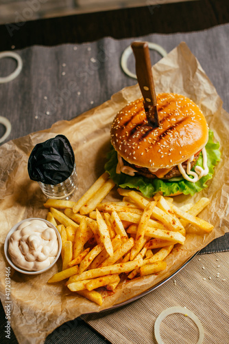 burger on a plate with french fries and sauce