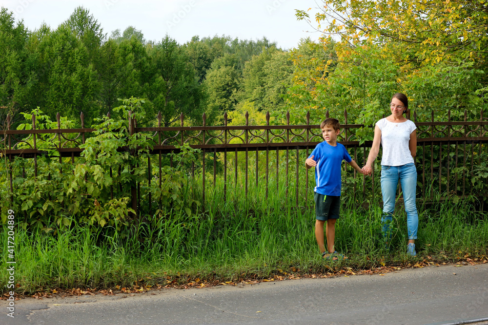 Mother and son ready to cross the road summer outdoor Mother and son ready to cross the road summer outdoor