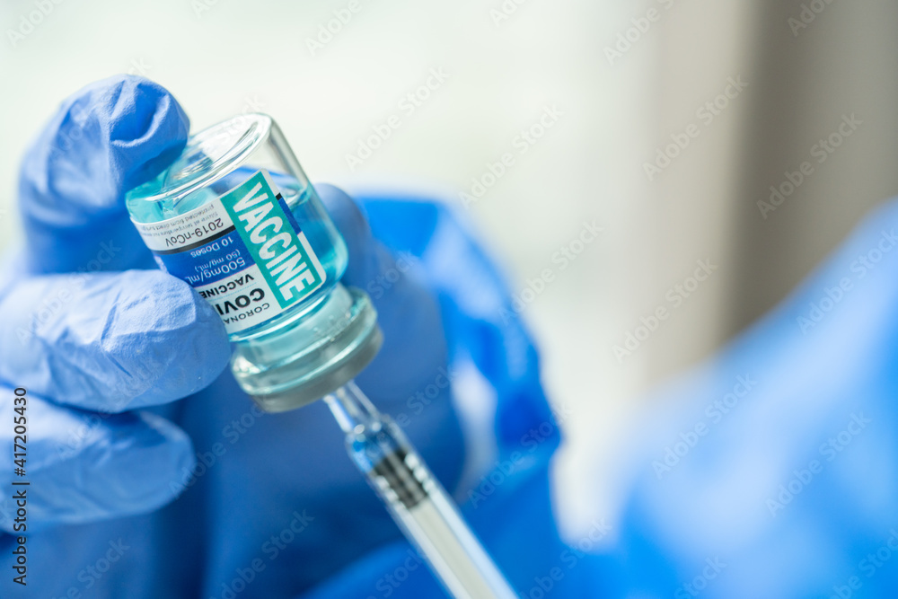 Medical concept ampoules or vials with Covid-19 vaccine on a laboratory bench. Medical concept ampoules or vials with Covid-19 vaccine on a laboratory bench.
