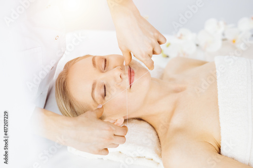 Beautiful caucasian woman getting face depilation procedure. Beauty and Spa salon concept