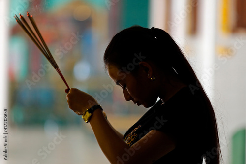 Sri Thenday Yutthapani Temple. Puja. Hindu woman praying with insence sticks. 31.01.2019 photo