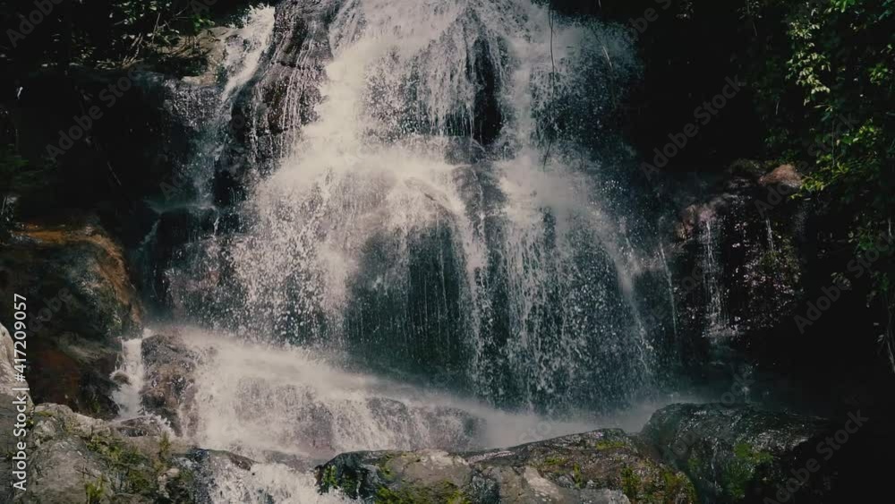 Close up waterfall in the jungle on a tropical island on a sunny day Close up waterfall in the jungle on a tropical island on a sunny day