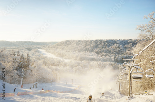 A view of the ski lift in the snow-covered forest after a blizzard in a fog. Winter wonderland. Gauja national park, Sigulda, Latvia. Seasons, recreation, sport, ecotourism, Christmas vacations