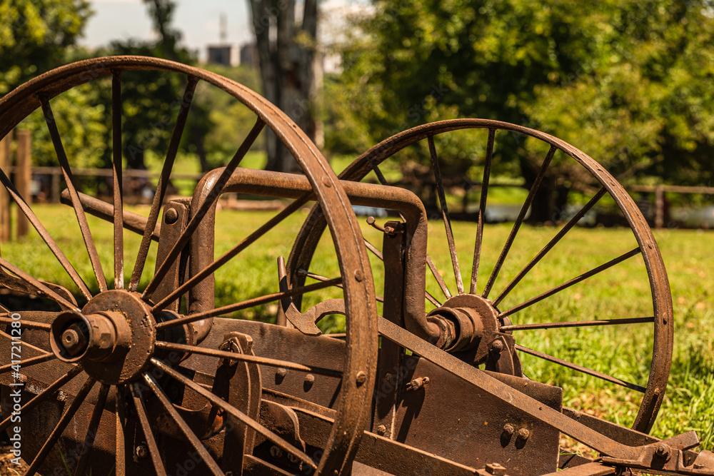 Old agricultural machines rusting in a farm