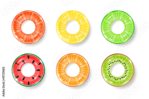 Inflatable rings looking like kiwi, orange and watermelon isolated on white background. Realistic colorful rubber swimming buoy. Vector illustration of top view at pool floater in fruit shape